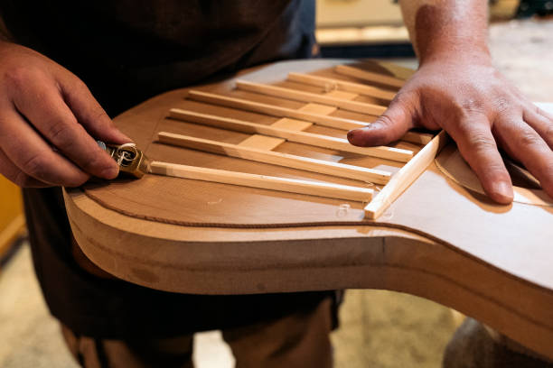 istock Craftsman Creating Musical Instrument 1447354268