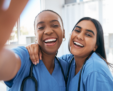 Healthcare, selfie and portrait of doctors working at a hospital, happy and smile while bonding and having fun. Face, friends and medical intern women relax, pose and embrace for picture at a clinic