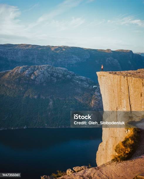 Woman Standing On Preikestolen And Looking At View Stock Photo - Download Image Now - Norway, Preikestolen - Norway, Camera Film