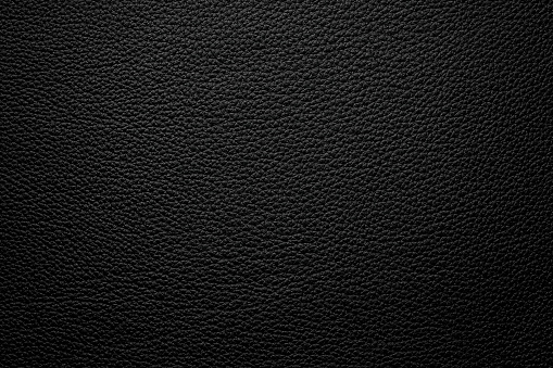 black leather background, natural hide texture closeup