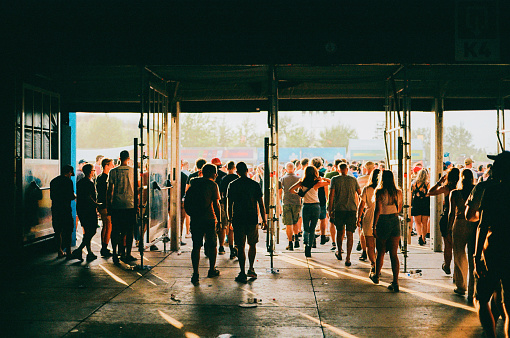 Crowd of people entering music festival. Shot on film