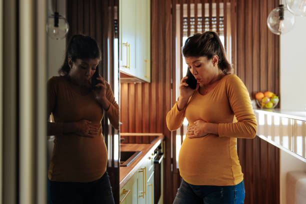 istock Pregnant woman calling hospital. 1447355561