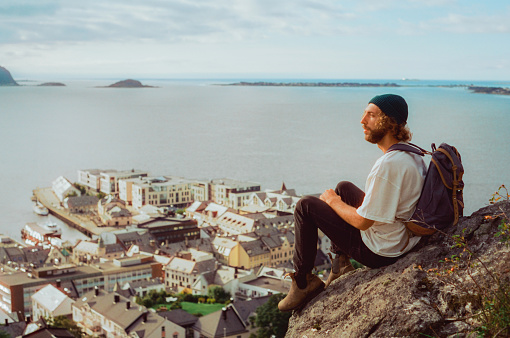 Young man looking at view of Alesund from above