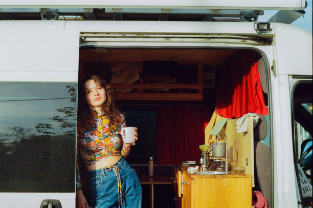 istock Woman standing in camper van and looking at camera 1447356488