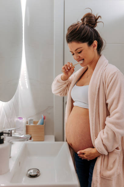 istock Pregnant woman brushing teeth. 1447356945