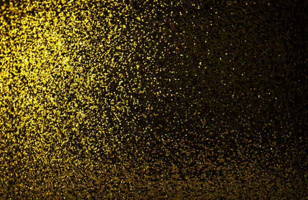 istock Dark yellow glitter background. Christmas dark sparkling background. 1447356995