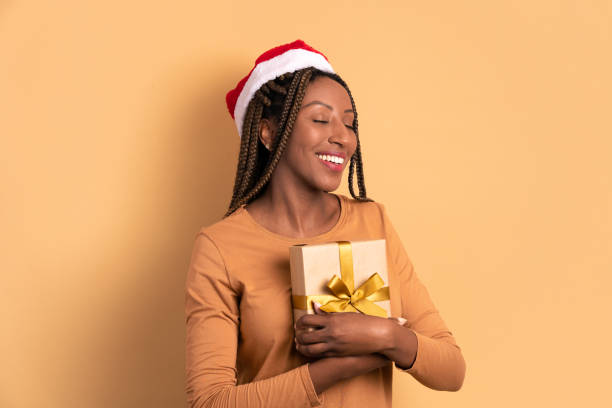 istock woman holding Christmas present 1447358182