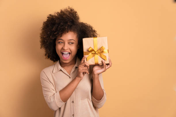 istock woman holding gift box 1447358673