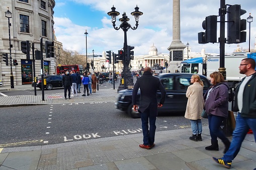 London, United Kingdom - March 6 2022: people waiting for pedestrian crossing on trafalgar square