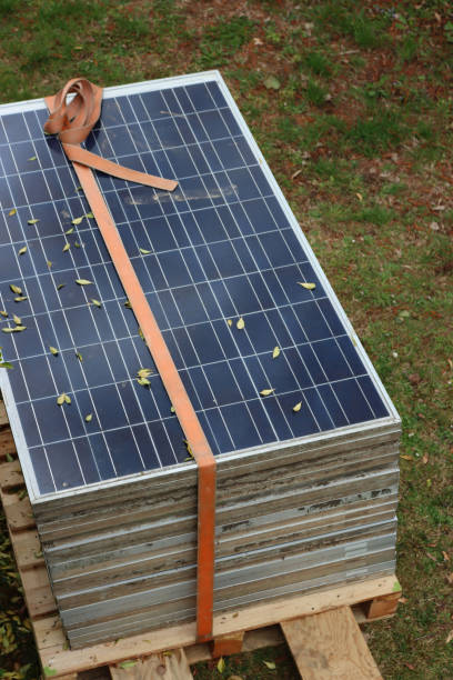 Close-up of many Solar panels on green grass background ready to be placed on the roof of a house