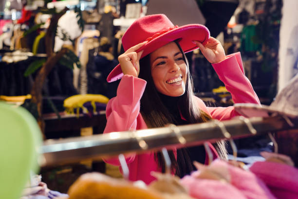 istock Beautiful young woman shopping for hat 1447361628
