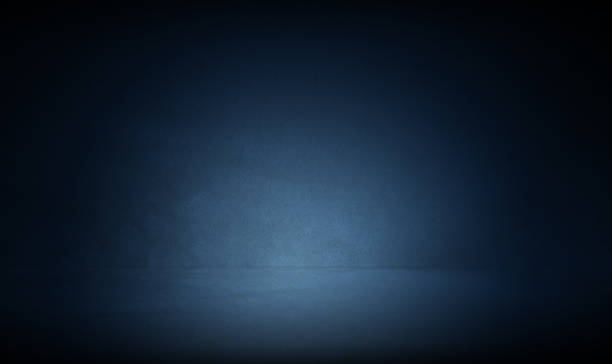 istock Three dimensional dark concrete room background with blue spot light for photograhy studio background, mock up design or product display 1447362048