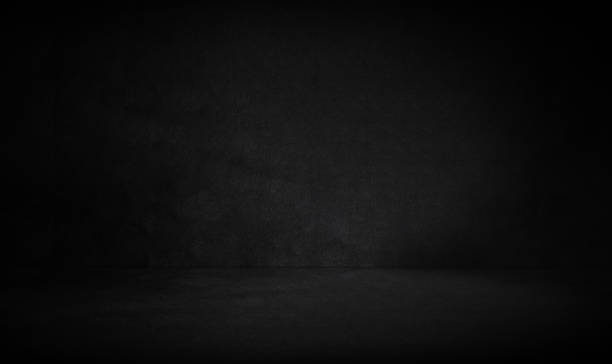 istock Empty dark three dimensional room with black concrete wall and floor and a low lighting 1447362806