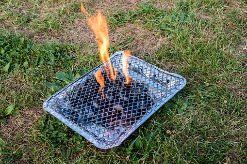 disposable grill on a meadow