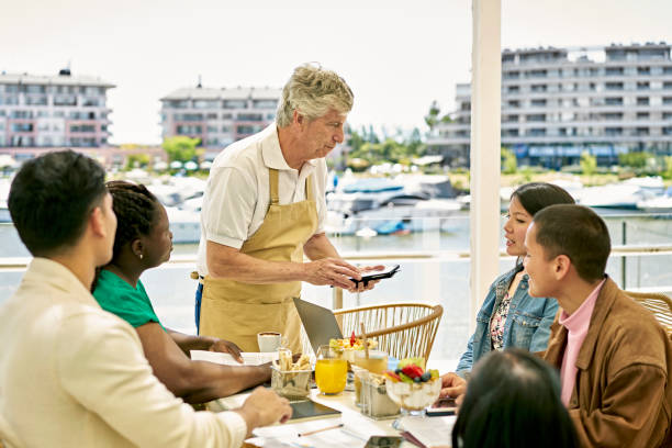 istock Waiter listening to restaurant guest 1447364822