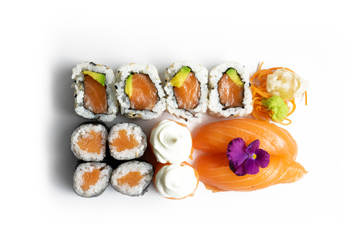 Set of sushi and maki with soy sauce over black background. Top view with copy space