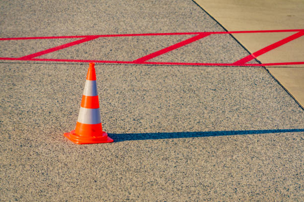 istock Orange traffic cone on airport 1447365925