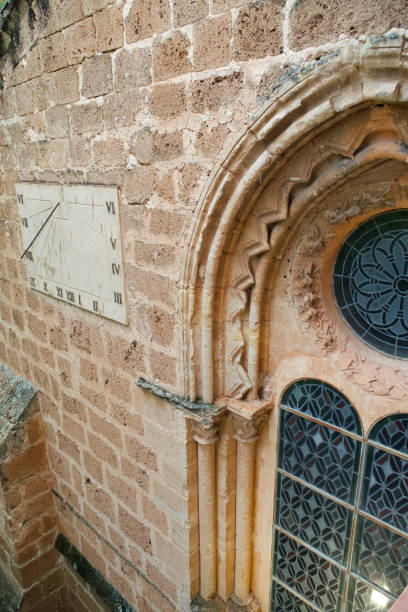 istock church glass and sundial on a stone wall 1447366164
