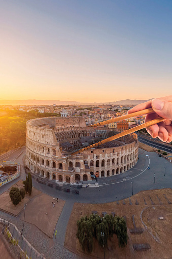 Chopsticks for sushi on the colosseum in rome