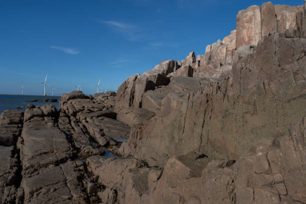 Seaside rocks and wind power in the setting sun