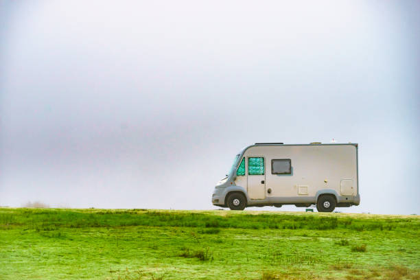 istock Camper rv camping on nature. Foggy day 1447371499