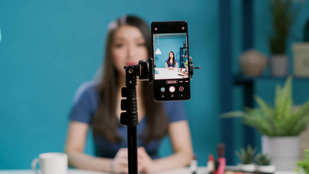 istock Asian female blogger recording makeup tutorial with broadcast equipment 1447375836