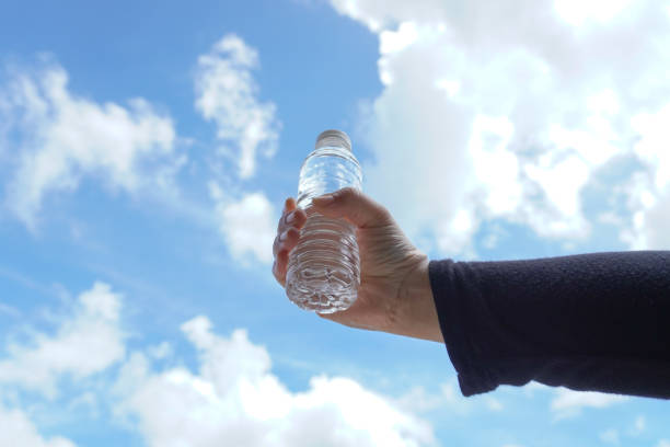 istock hand holding a small mineral water bottle 1447376907