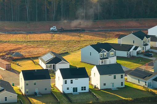 Aerial view of real estate development with tightly located family houses under construction in Carolinas suburban area. Concept of growing american suburbs.