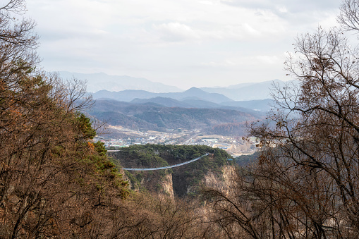 wonju suspension bridge viewed from far surrounded by mountains. Taken in Wonju, South Korea