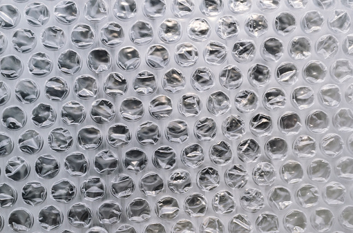 clear bubble wrap surface texture. plastic with air balls. used for packing glassware or electronics or sensitive goods
