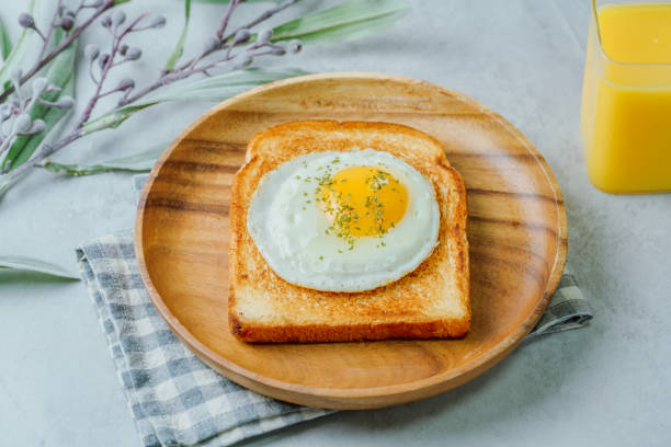 istock Fried egg crispy toast food on wood plate 1447388471