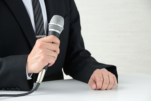 Business man explainign with microphone
