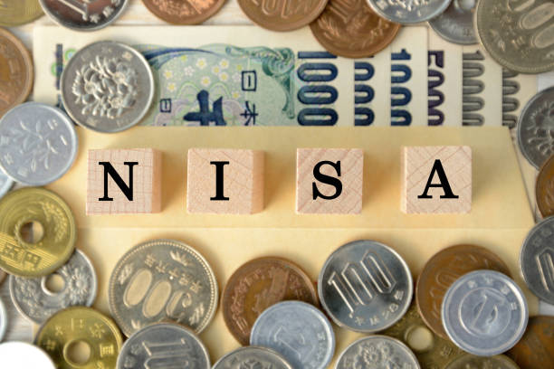 japanese money and wooden blcoks with "nisa" word - retirement investment capital letter text imagens e fotografias de stock