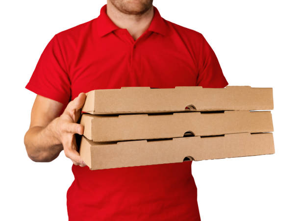 istock delivery man in red uniform with pizza boxes in hands isolated on white background 1447391041