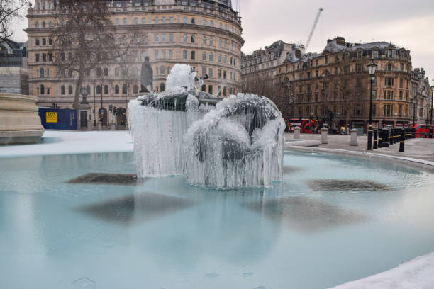 Frozen fountain in Trafalgar Square, London, UK London, UK - February 11 2021: Frozen fountain in Trafalgar Square as temperatures dropped in the capital. winter wonderland london stock pictures, royalty-free photos & images