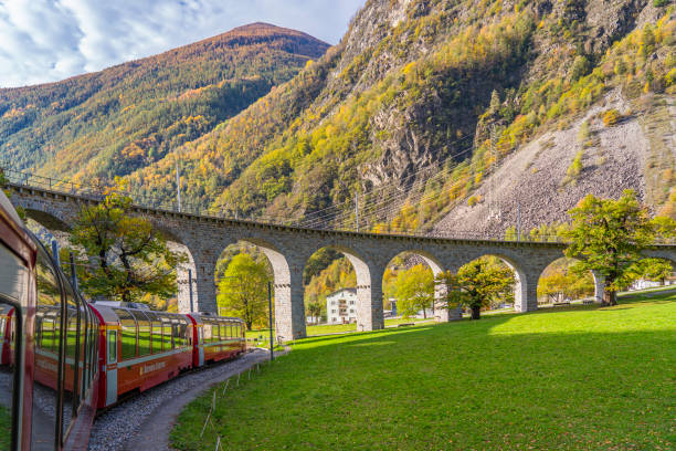 Bernina Express of Rhaetian Railway Line at the Brusio spiral viaduct on a autumn day, stock photo