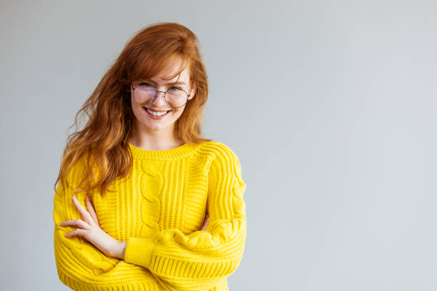 istock Smiling friendly young woman with long red hair 1447394734