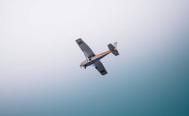 istock Aircraft flying on a blueand white  sky 1447396666