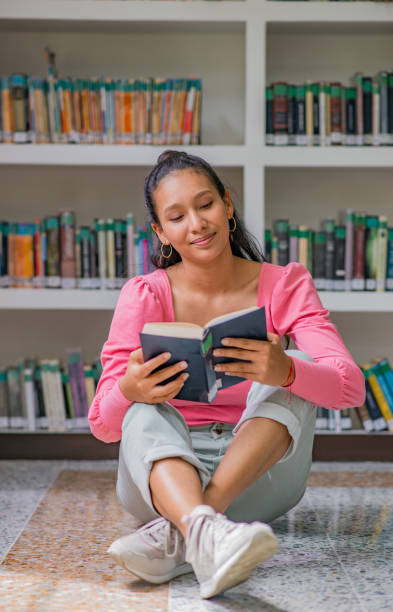 istock young university student in the library reading a book, student doing research at the library 1447396780