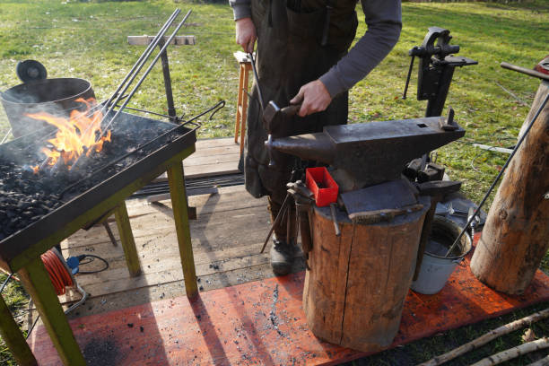 istock Blacksmith at handwork and glowing coals and iron 1447397556