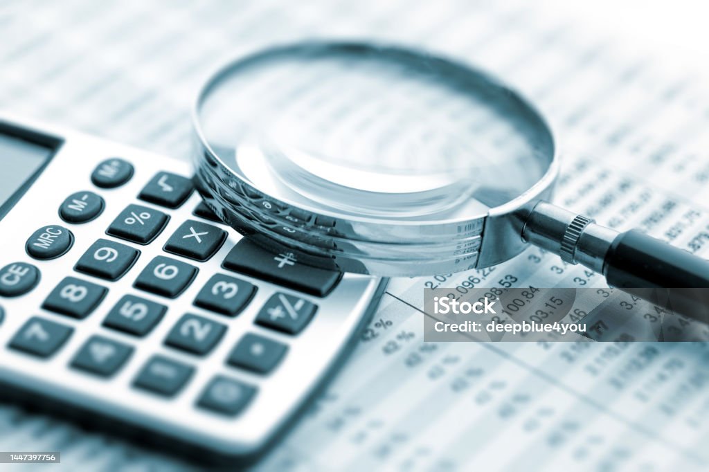 Magnifying glass on financial chart Magnifying Glass Stock Photo