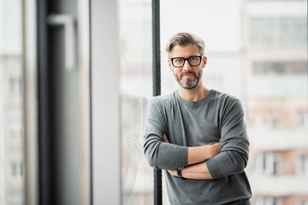 istock Businessman close up portrait while standing at the office 1447399767