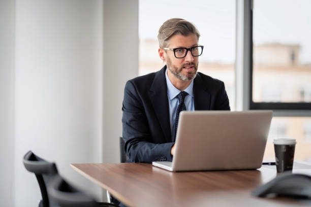istock Executive businessman with laptop working at the office 1447399794