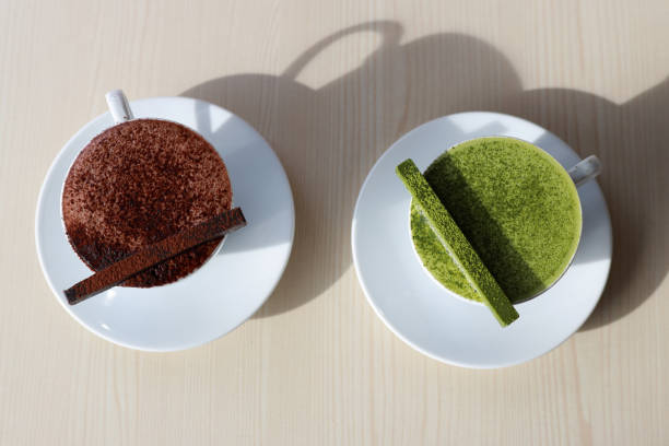 A cup of green tea latte with a chocolate bar on a wooden table in a cafe
