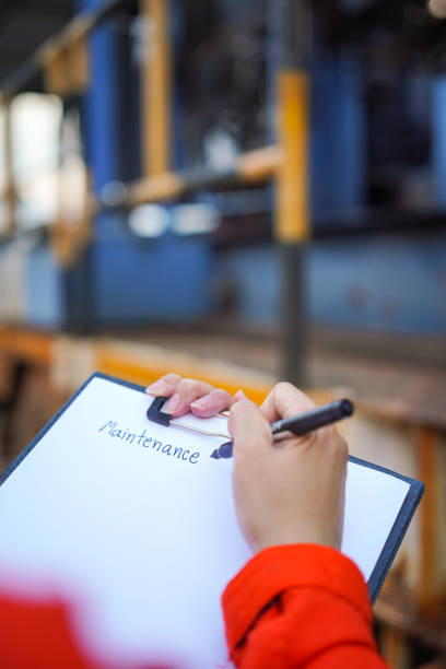 istock Writing on the preventive maintenance checklist of the heavy machine. 1447400459