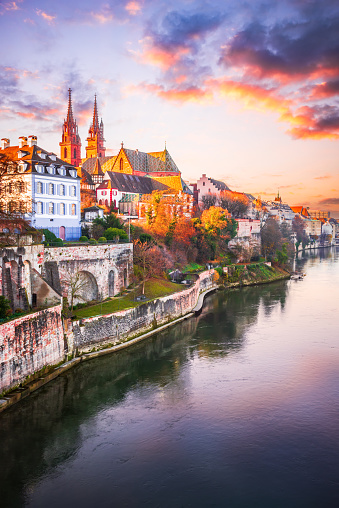 Basel, Switzerland. Beautiful city on Rhine River banks with Munster Cathedral sunset colors. Charming Swiss landscape.