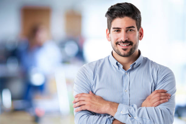 istock Confident businessman portrait while standing at the office and smiling 1447400583