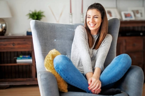 istock Smiling woman portrait while relaxing at home 1447400630