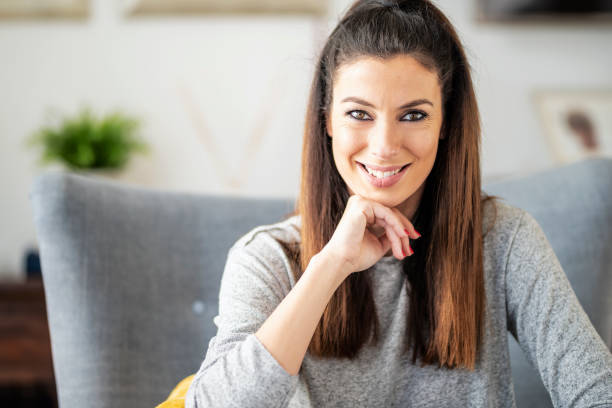 istock Smiling woman portrait while relaxing at home 1447400661