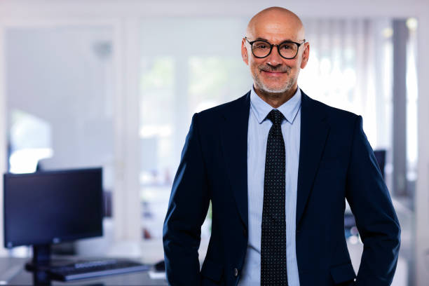 istock Middle aged businessman standing at the office 1447400702
